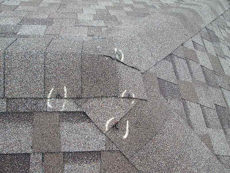 Hail damage on roofing shingles.