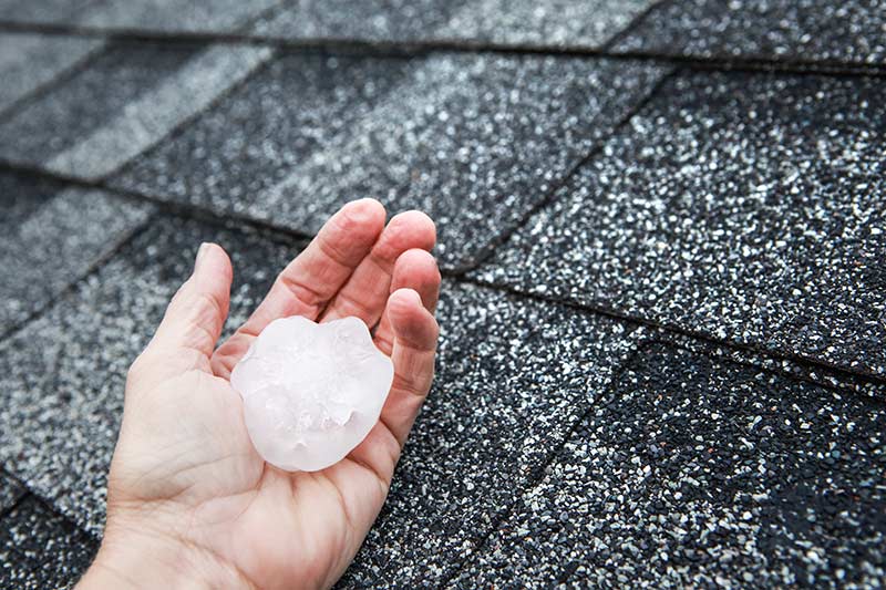 Large hail on a roof after a hailstorm.