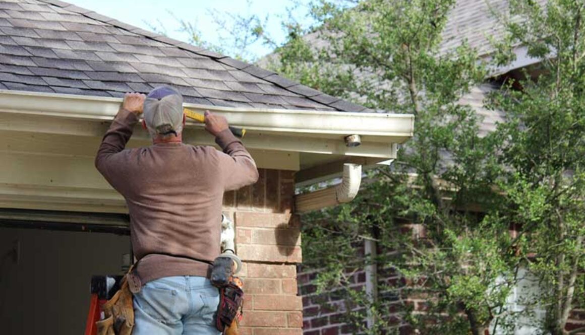Professional installing gutters