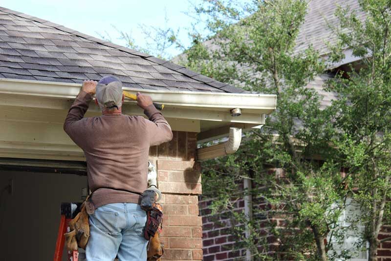 Professional installing gutters